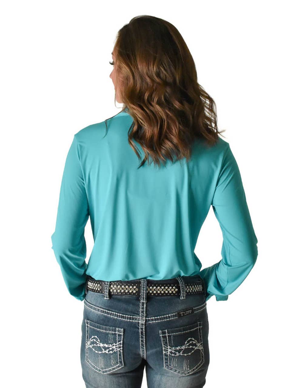 Back view of a woman wearing the Cowgirl Tuff Rodeo Shirt Turquoise Breathe Pullover, paired with stylish jeans.