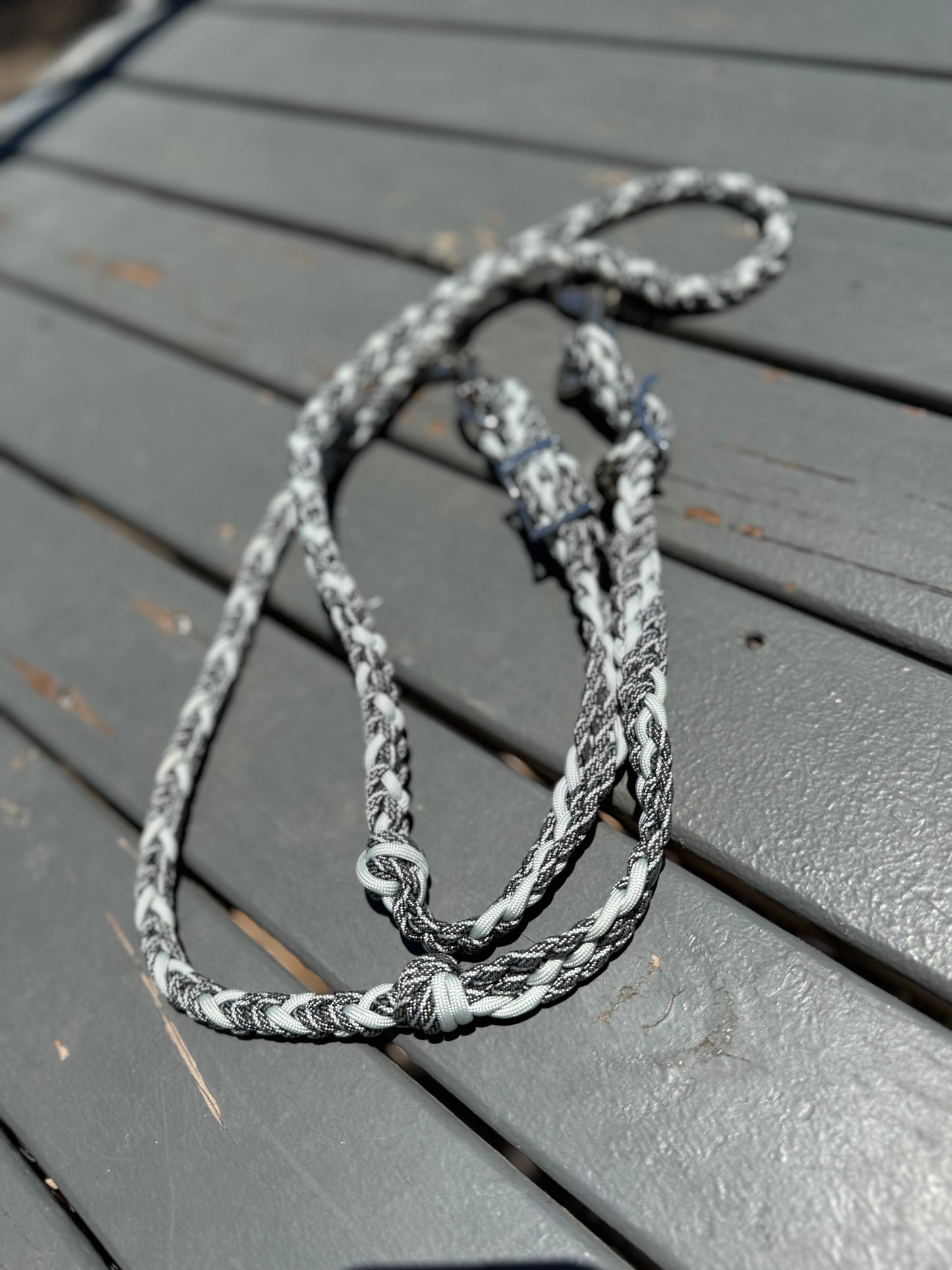 Braided gray and white rope on a wooden surface