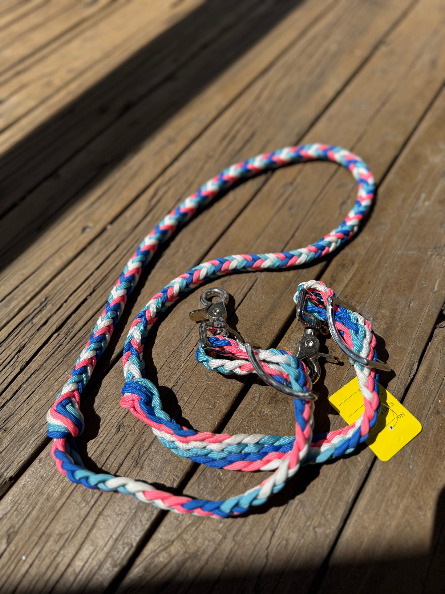 A set of pink, blue and white hand-braided barrel racing reins