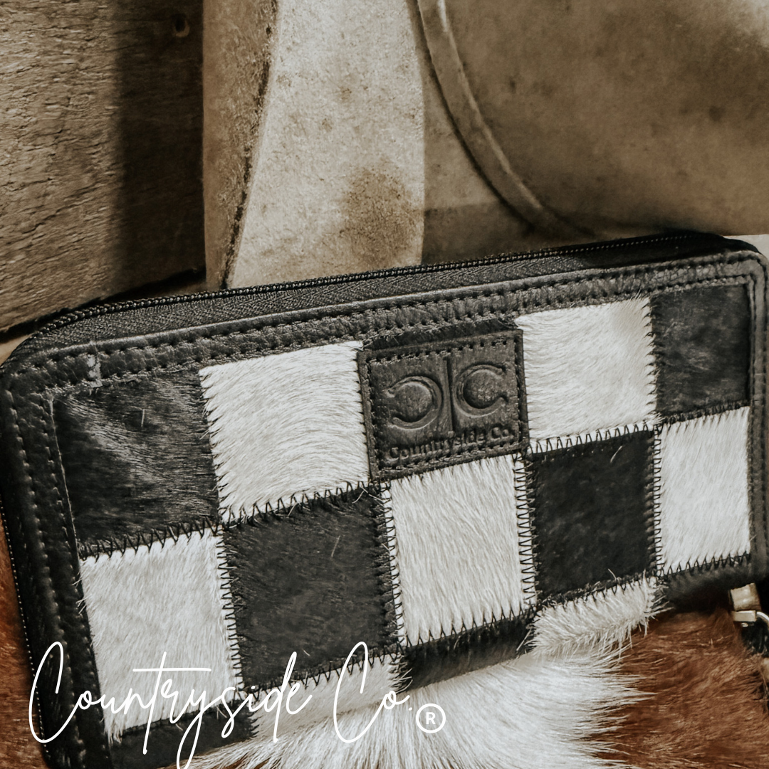 Patchwork wallet with black, white, and gray pattern on a textured surface, featuring 'Countryside Co' branding.