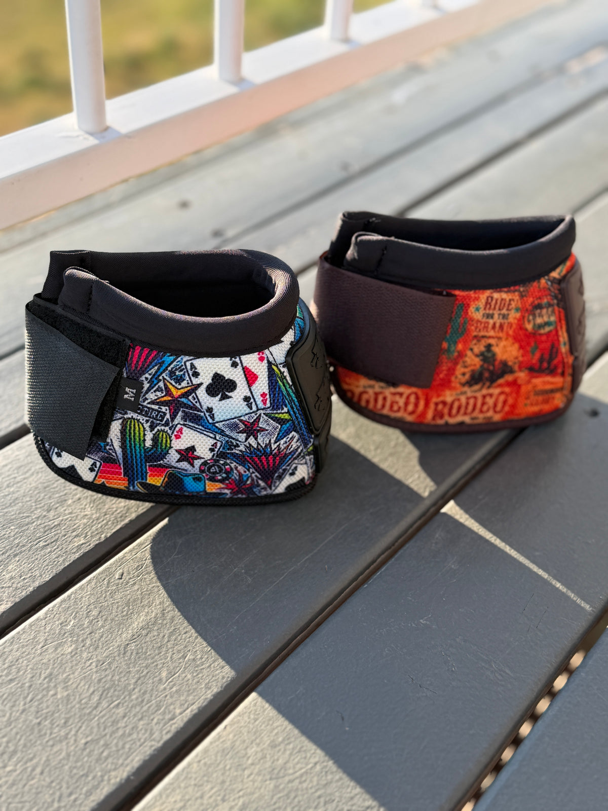 Side view of High Stakes and 8 Seconds bell boots with playing-card and orange rodeo prints and adjustable closures.
