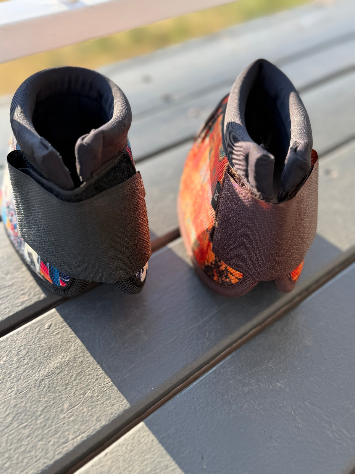 High Stakes and 8 Seconds bell boots viewed from above, showing padded top edges and wide fastening straps.