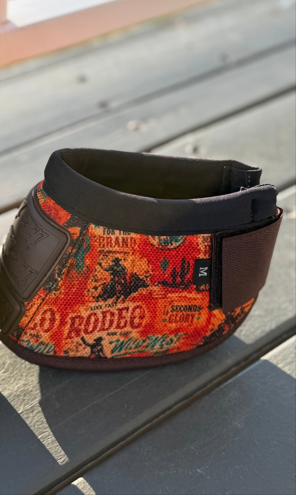 8 Seconds sport boot and matching bell boot with orange rodeo print, brown straps and bar3H rubber panels.