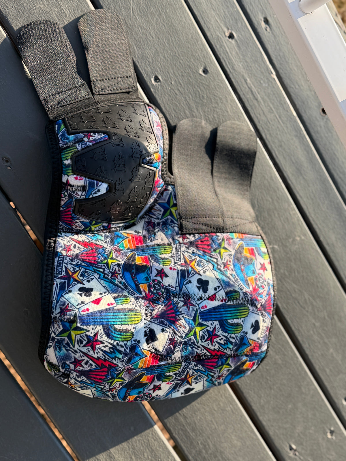 High Stakes sport boot laid open, showing colourful cards, cacti and stars, black fastening straps and rubber panel.