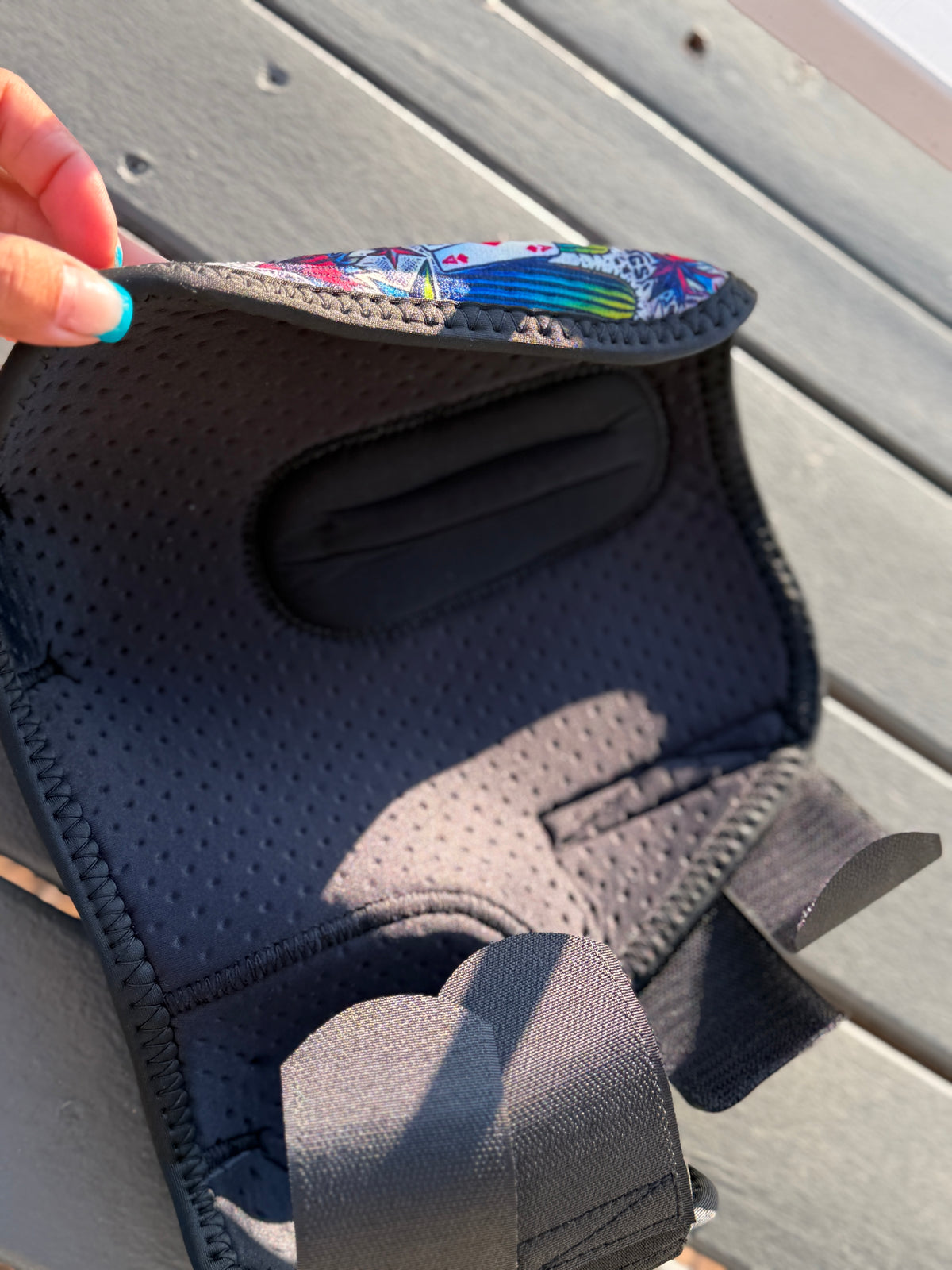 Inside of a High Stakes sport boot, showing perforated lining, shaped inner pad and black fastening straps.