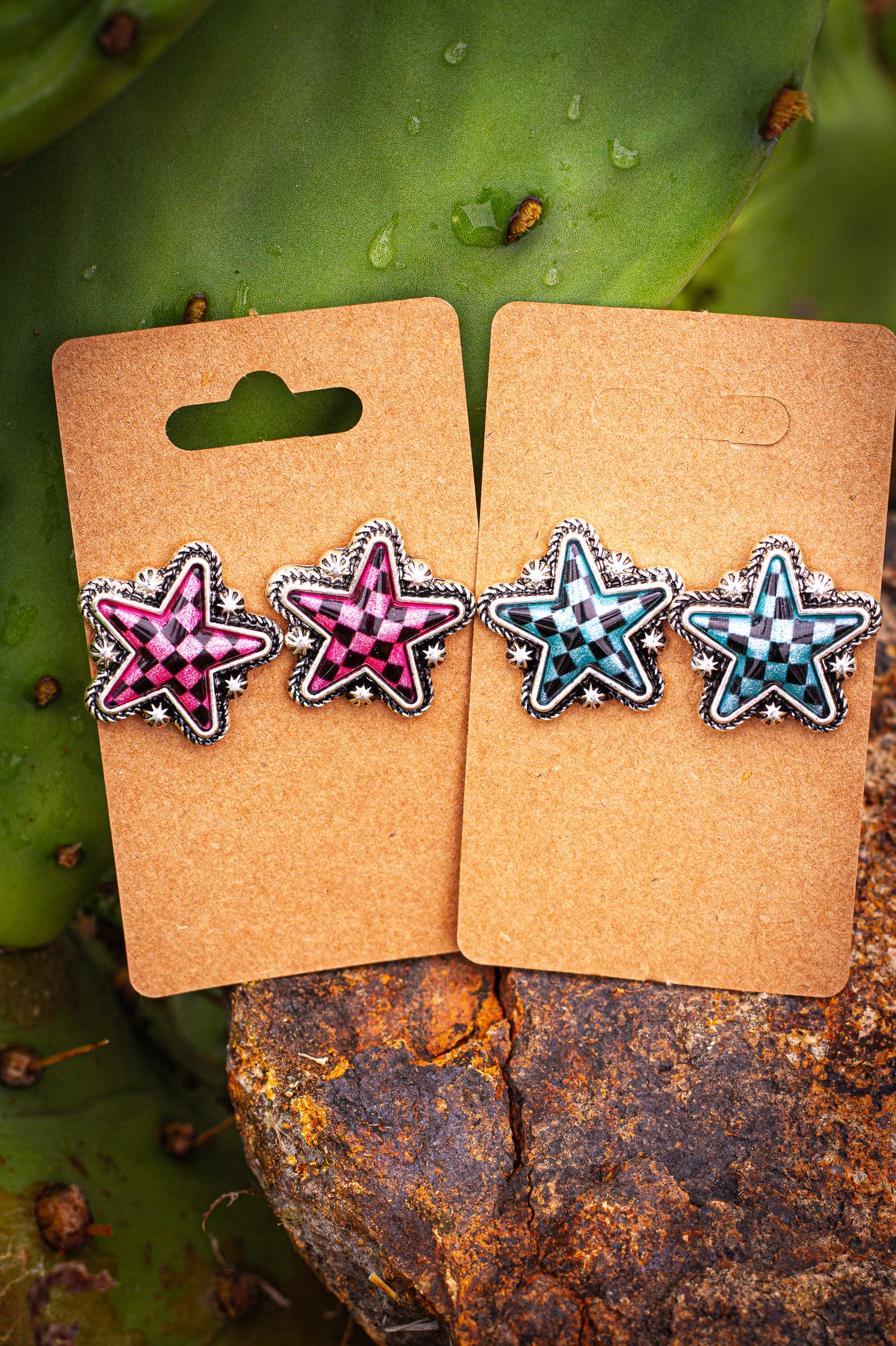 Star-shaped checker earrings on brown card packaging with a natural background