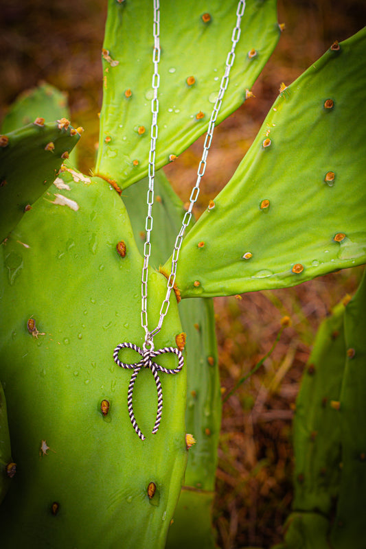 Necklace with a bow pendant on a cactus leaf