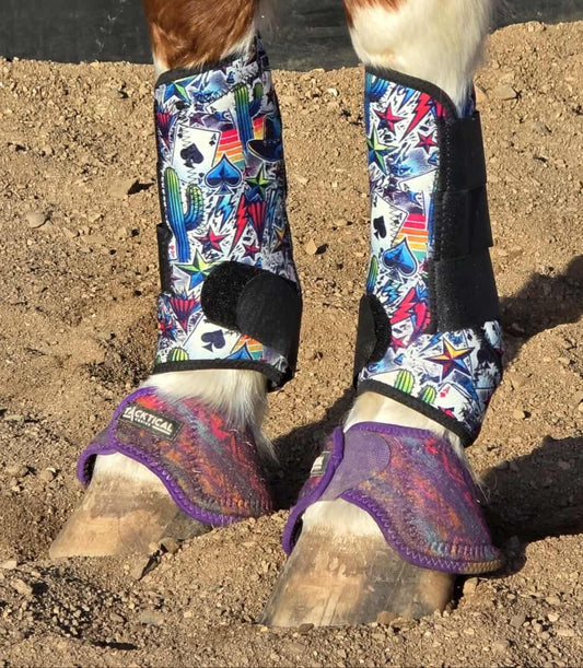 High Stakes protective horse boots with bold casino-themed print and black trim, shown on a chestnut horse wearing purple bell boots in a sandy arena.