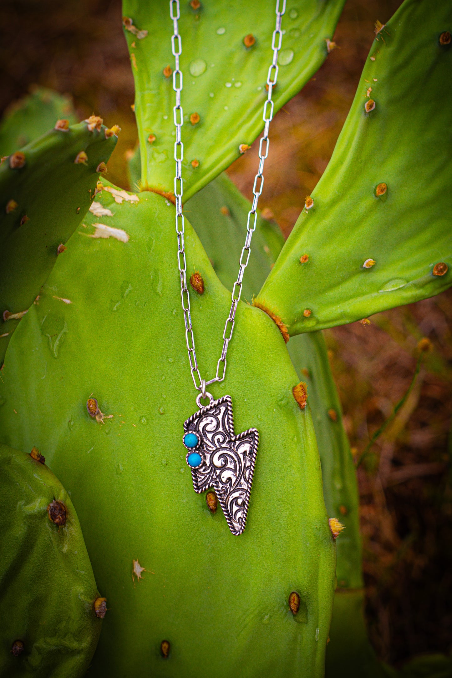 Silver necklace with lightening bolt pendent with turquoise stones